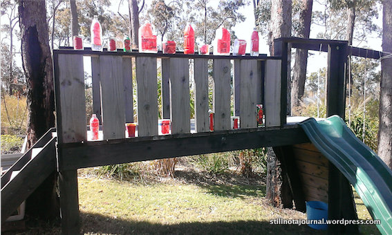 An assortment of unbreakable household rubbish, sloshed with red acrylic paint and weighed down with a bit of water. Plus one clue.