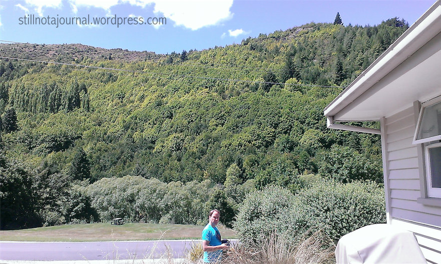The view from our side deck. Hidden in the trees at the bottom of that hill mountain is the Arrow River. Walk into the trees then turn left for Arrowtown.