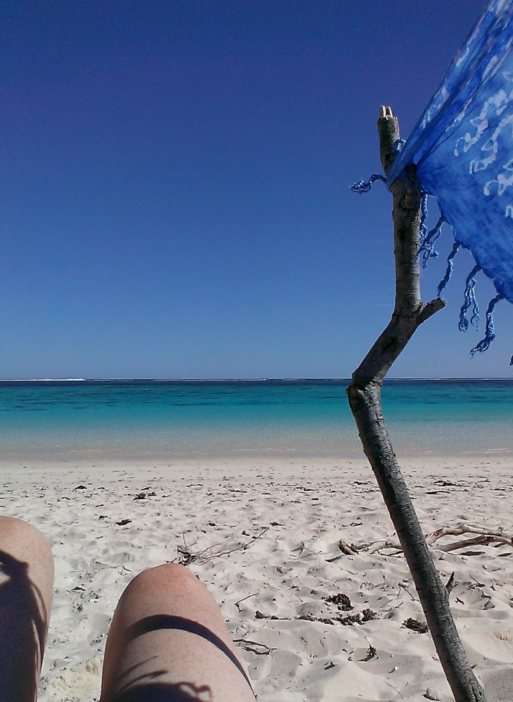 Enjoying the view from my makeshift sun shelter; a stick, the fence line and my sarong. Glad I had something; even in midwinter the sun was vicious and there is no shade. Stuff getting shipwrecked around here!