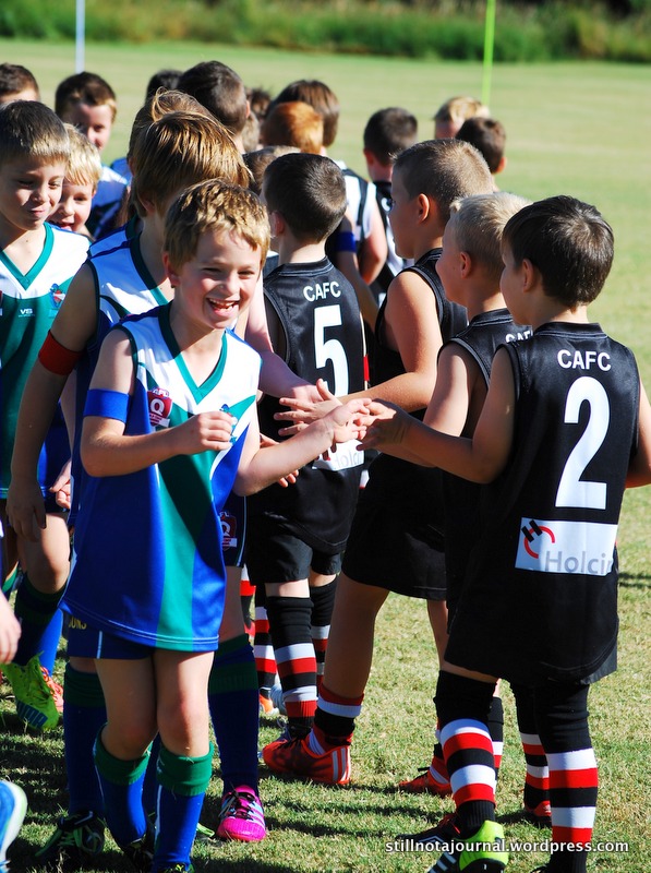 The traditional post-game team hand shake and cheer for the opposing team. Onya guys!